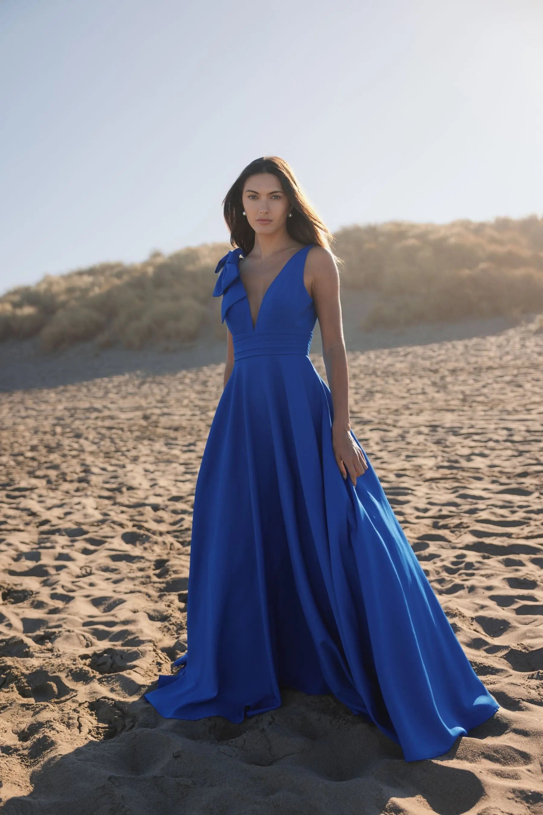 Blue Sleeveless Plunge Neck Ball Gown With Bow Detail | Mac Duggal Blue Sleeveless Plunge Neck Ball Gown With Bow Detail | Mac Duggal