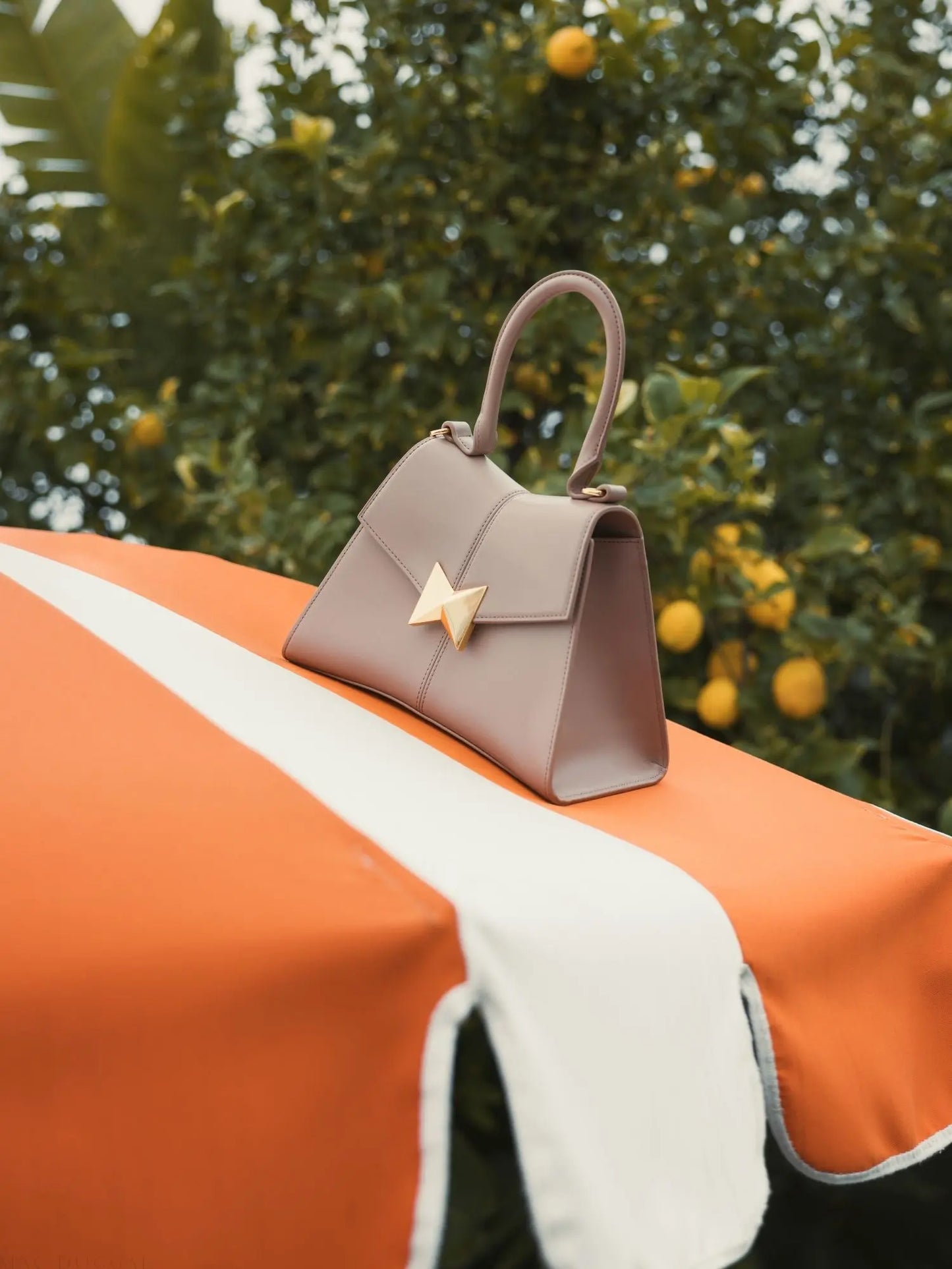 Angular Small Taupe Leather Handbag With Gold Hardware - Mac Duggal